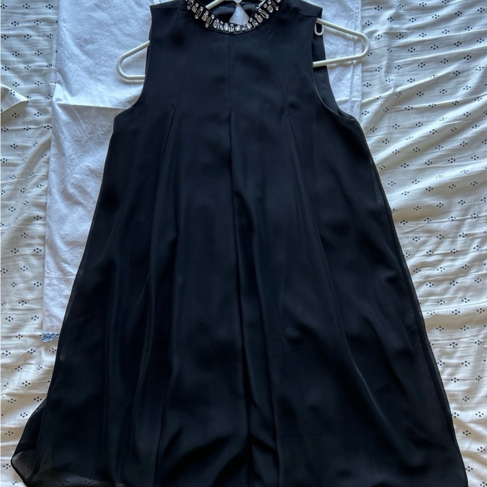 Elegant Black Sleeveless Dress with Embellished Neckline BCBGeneration